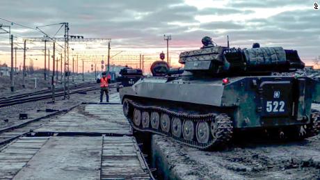 In this image taken from a video provided by the Russian Defense Ministry on Tuesday, Russian armored vehicles are loaded onto railway platforms after the end of military exercises. 