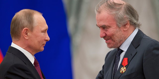 Russian President Vladimir Putin, left, presents a medal to Valery Gergiev, artistic director of the Mariinsky Theatre, during an award ceremony in Moscow.