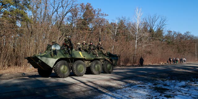 Members of the Ukrainian forces sit on a military vehicle amid the Russian invasion of Ukraine, in the Vyshgorod region near Kyiv, Ukraine, March 10, 2022.  