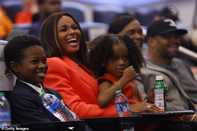 Happy to be in Colorado: Ciara is seen flashing a big smile as she sits and watches the conference with her kids next to her