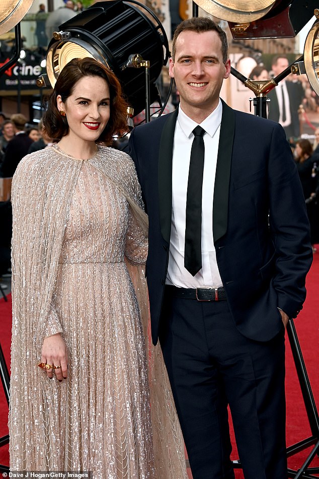Thrilling: While making her red carpet debut as an engaged couple, Michelle sparkled in an eye-catching silver dress at the premiere of Downton Abbey: New Era London