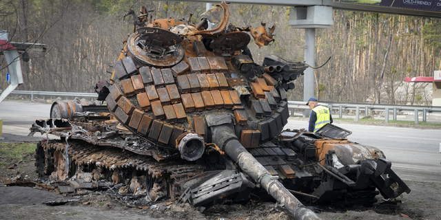 A damaged Russian tank is seen on a highway to Kyiv, Ukraine.