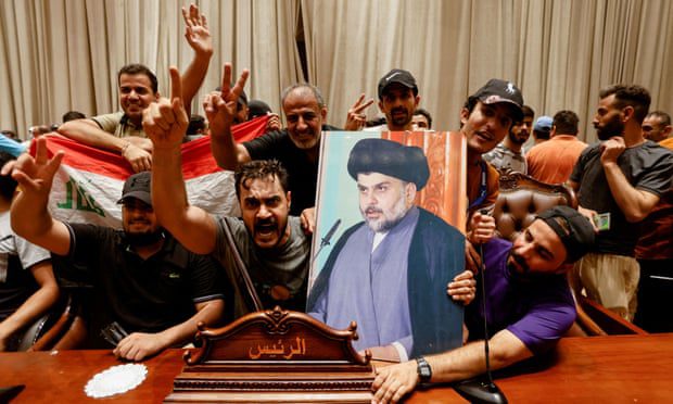 Supporters carry a picture of Iraqi Shiite cleric Muqtada al-Sadr inside the parliament building in Baghdad.
