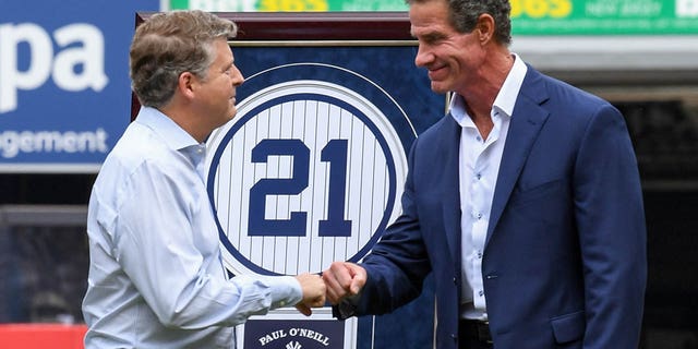 Former New York Yankees player Paul O'Neill shocks owner Hal Steinbrenner during his number retirement party before the game between the New York Yankees and the Toronto Blue Jays at Yankee Stadium on August 21, 2022 in New York.