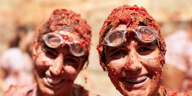 Revelers enjoy the atmosphere in tomato pulp as they take part in the annual Tomatina Festival in Buñol, Spain, on Wednesday, August 31, 2022.