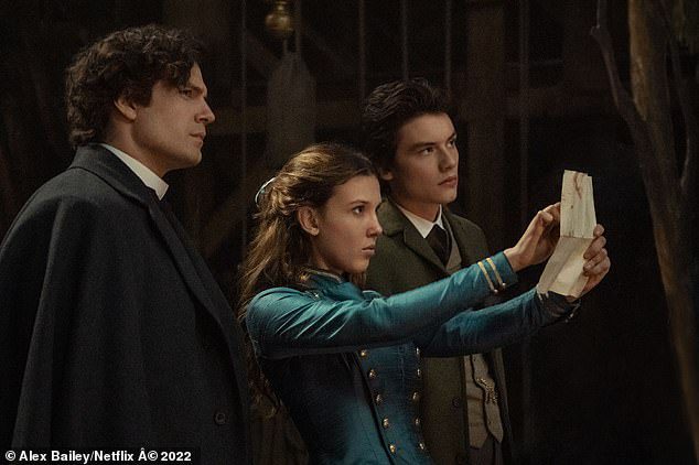 Back to work: Henry (left) will appear alongside Millie Bobby Brown (centre) as Sherlock Holmes in the Netflix hit Enola Holmes 2 (right Louis Partridge as Tewkesbury)