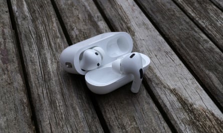 AirPods Pro 2 case open on a table with one earbud hanging on the cover.
