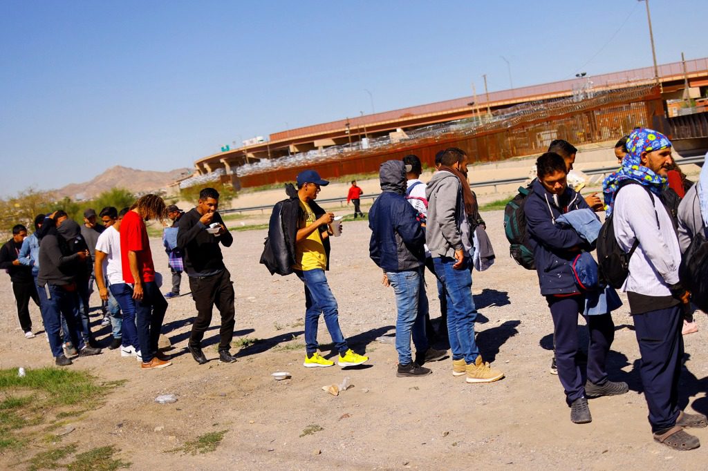 Venezuelan immigrants, some of whom were expelled from the United States to Mexico under Section 42 and others who have not yet crossed, line up to receive donated food from members of a Christian church near the Paso del Norte International Border Bridge, in Ciudad Juarez, Mexico October 20, 2022. 