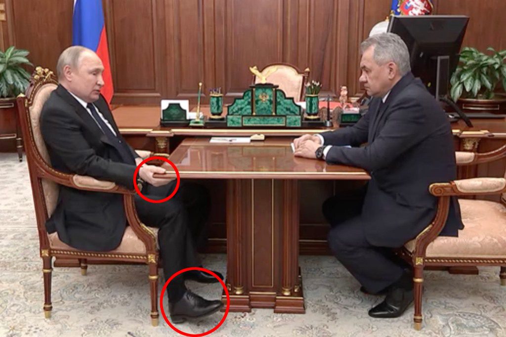 Vladimir Putin holds a table at a recent meeting, which has led to speculation about his health.
