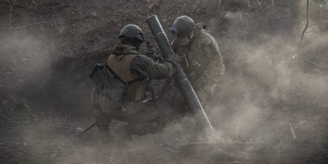 Ukrainian soldiers watch after firing mortars at the Toritsk front line in Donbass, Ukraine, December 2, 2022. 