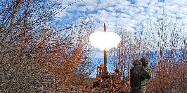 Armed members of the Donetsk People's Republic (DPR) fire howitzer shells at the Bakhmut border front in Donetsk, Ukraine on December 1, 2022. 